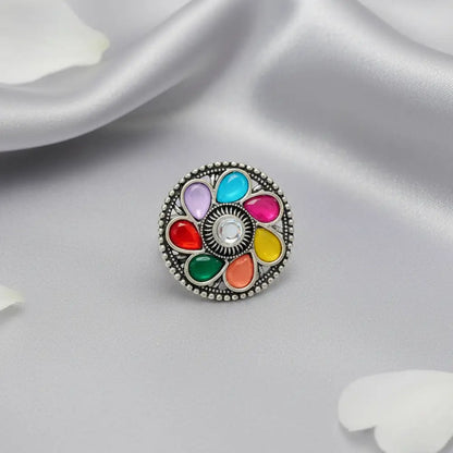 Multicolored circular charm on a white fabric background