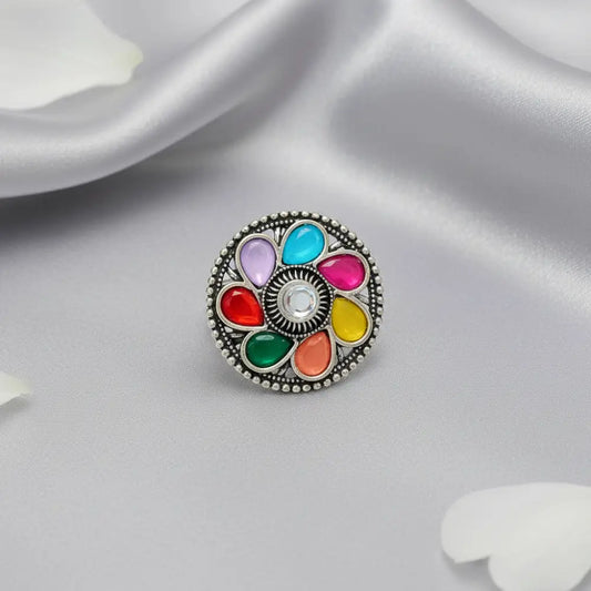 Multicolored circular charm on a white fabric background