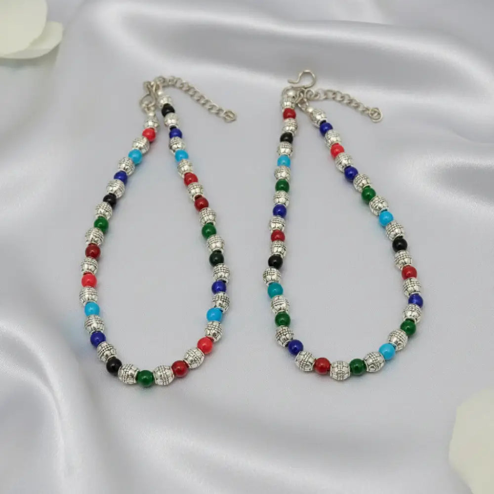 Two colorful beaded necklaces on a satin surface