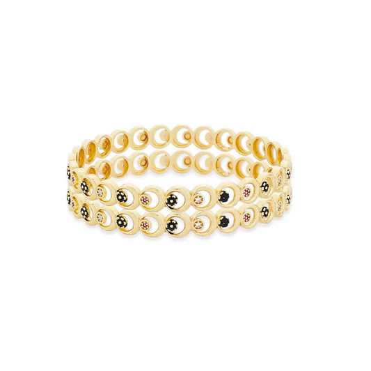 Set of gold bangles with small stones on a white background