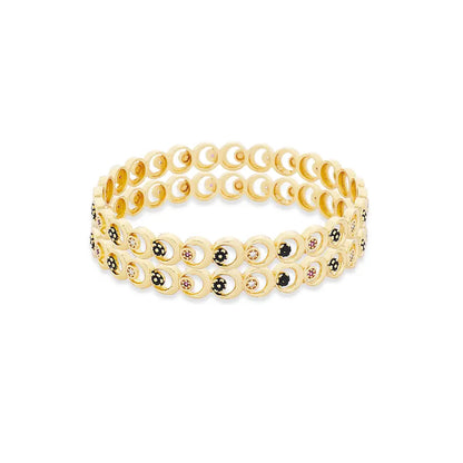 Gold Bangles with circular design on a white background