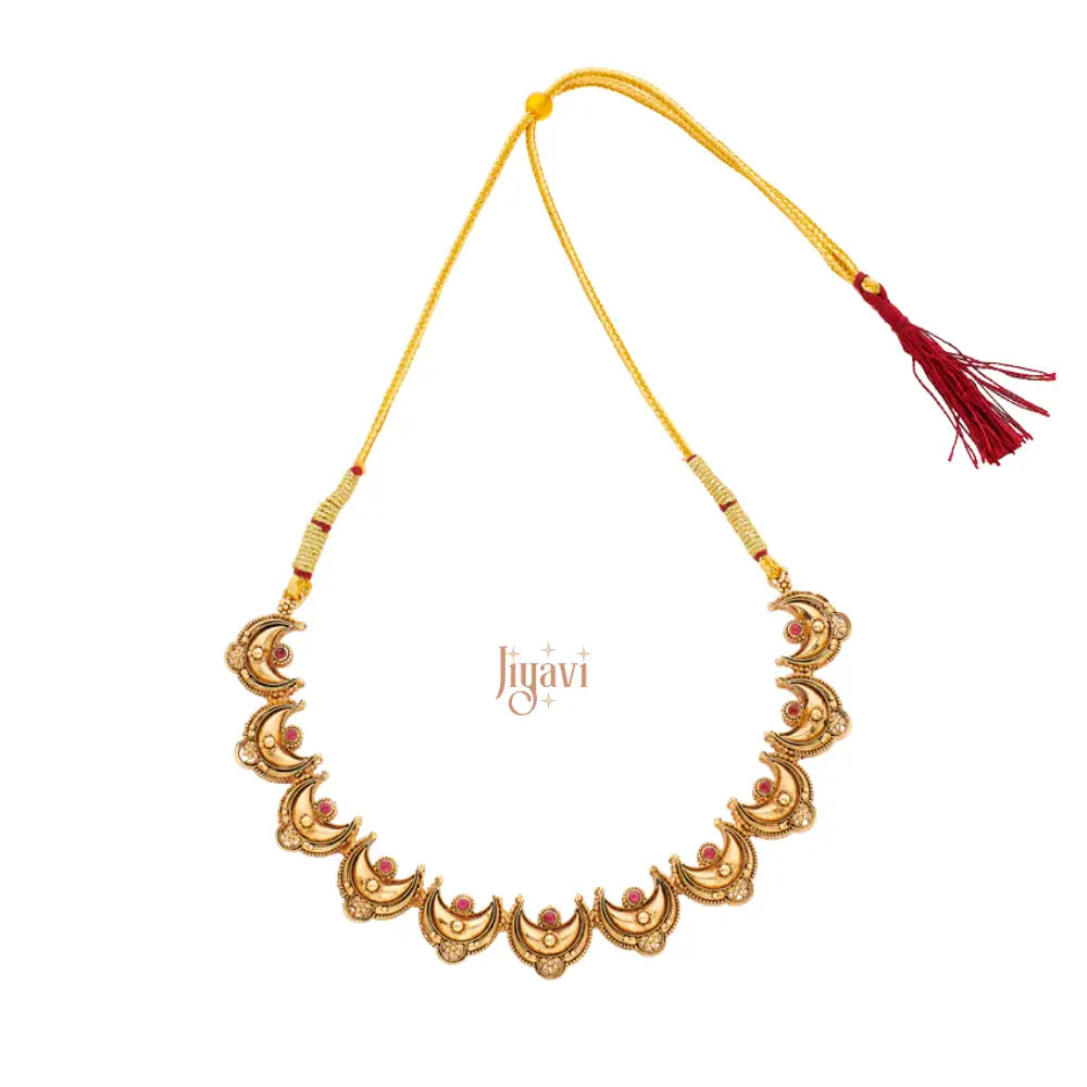 Decorative gold necklace with red tassel on a white background, featuring the brand 'Jiyavi'.