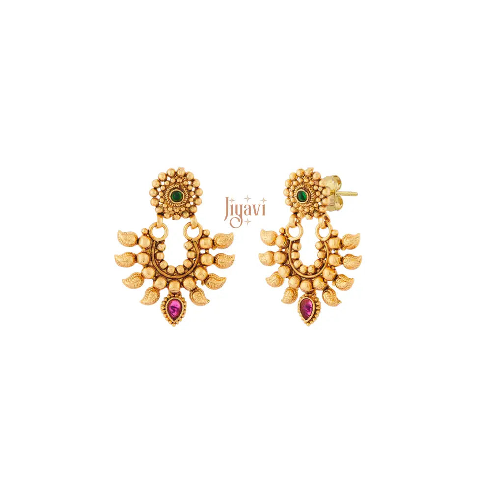 Pair of gold earrings with gemstones on a white background, branded 'Jiyavi'.