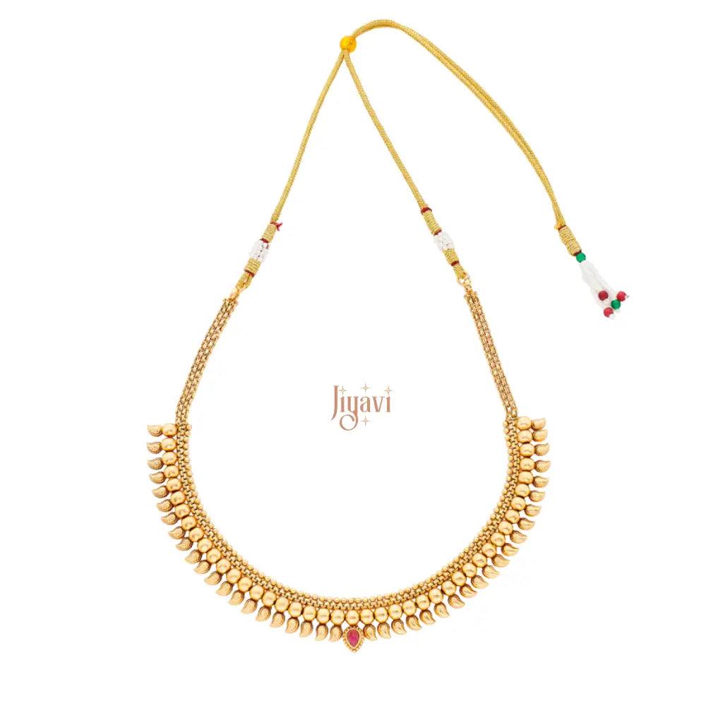 Gold necklace with red stones on a white background, featuring the brand 'Jiyavi'.