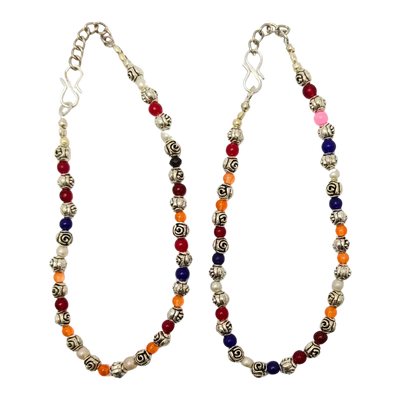 Colorful beaded necklace with silver chain on a white background