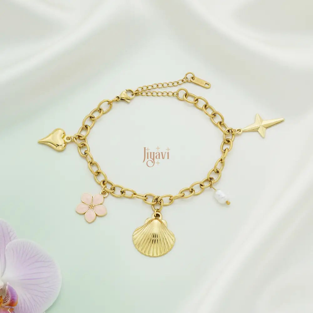Gold bracelet with charms on a white background