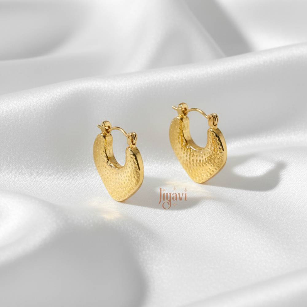Gold hoop earrings on a white satin background with 'Jiyavi' branding.