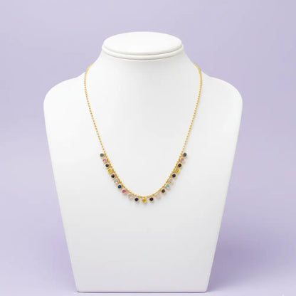 Necklace on a mannequin bust against a light purple background