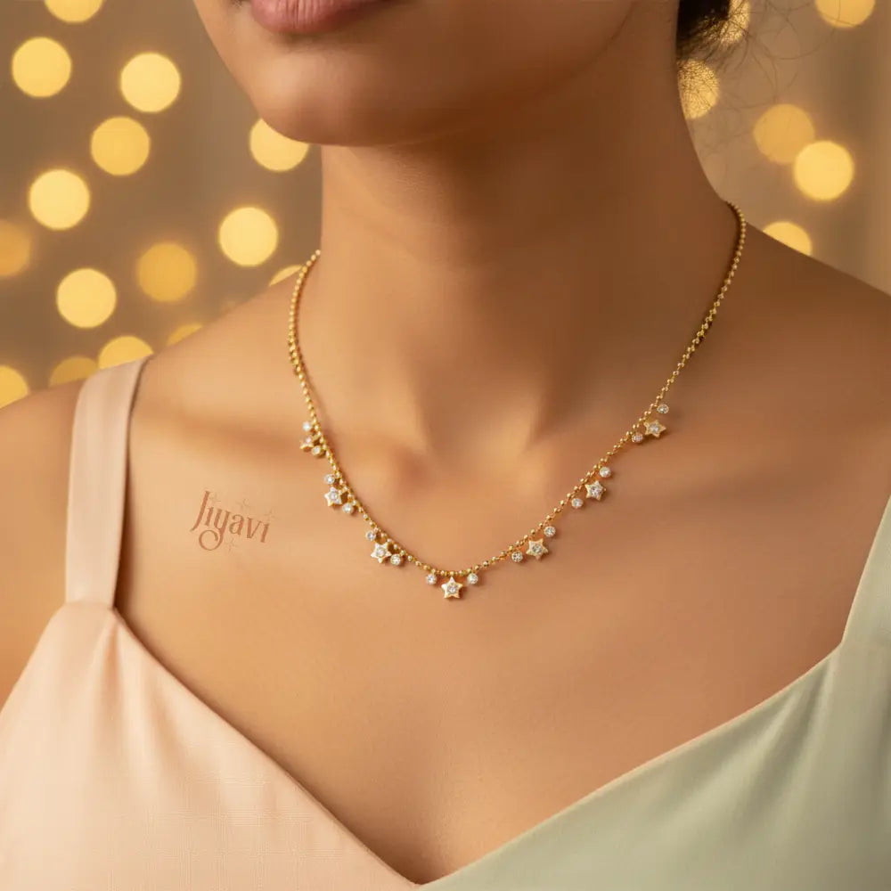Gold necklace on a model with a blurred bokeh background