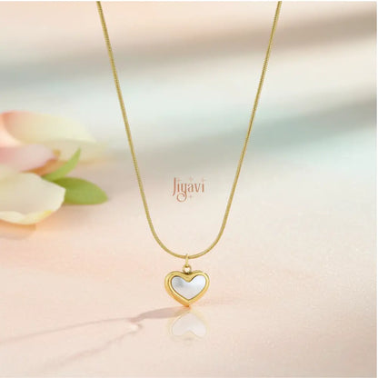 Gold necklace with a heart-shaped pendant on a soft background