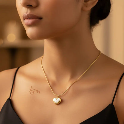 Woman wearing a gold necklace with a heart pendant, brand 'Jewelry' visible.